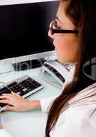 side pose of woman working on computer