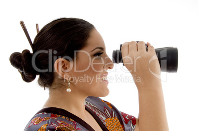 side pose of female watching through binocular