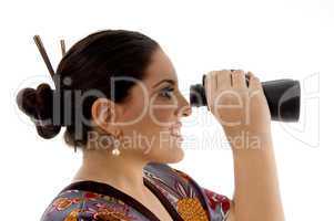 side pose of female watching through binocular