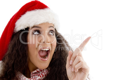 young woman with christmas hat indicating upward