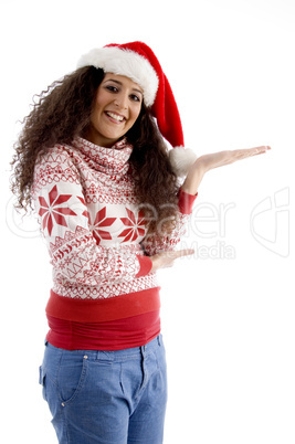 smiling young female with christmas hat and open palm