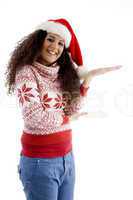 smiling young female with christmas hat and open palm