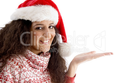 smiling young woman with christmas hat and open palm