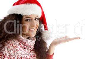 smiling young woman with christmas hat and open palm