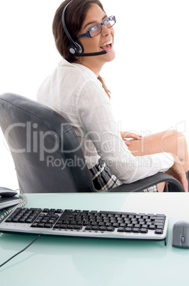 side view of smiling woman sitting in office