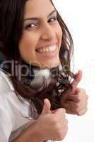 caucasian female wearing headphones and gesturing thumbs up