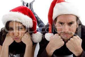 close up view of young couple wearing christmas hat and looking at camera