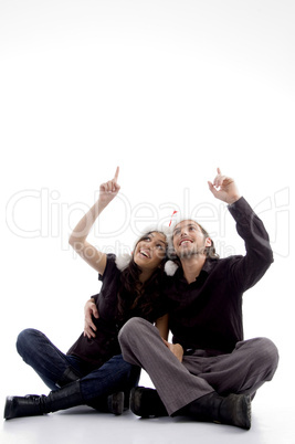 young couple wearing christmas hat with hand gesture