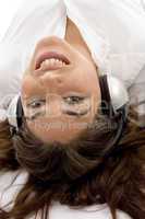close up view of young female lying and wearing headphones