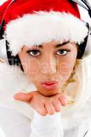 pretty woman wearing christmas hat giving flying kiss