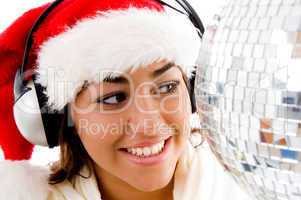smiling young girl posing in christmas hat and listening to songs