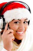 beautiful woman wearing christmas hat and enjoying music