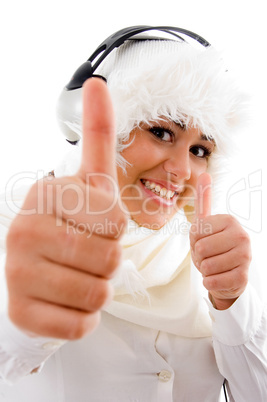 happy woman listening to music and showing thumbs up