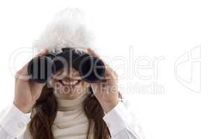 woman in winter wear watching through binocular