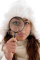 female looking through magnifying glass