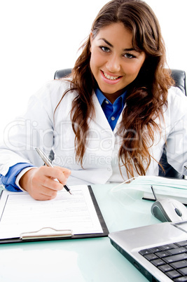 smiling doctor writing prescription