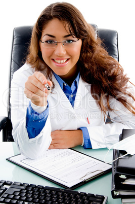 portrait of smiling doctor pointing from pen