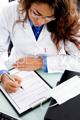 high angle view of young doctor writing prescription