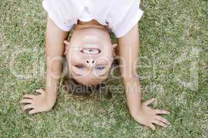girl doing cartwheel in the grass