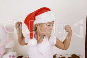 strong little girl wearing christmas hat