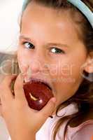 cute little girl eating fresh apple