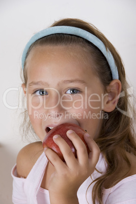 little girl eating apple