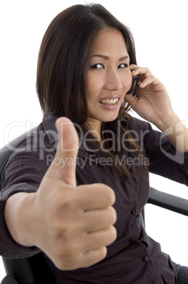 woman showing thumbs up while talking