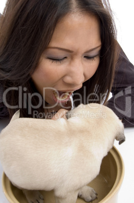 pretty woman playing with puppy