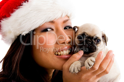 portrait of smiling woman with christmas hat and pug