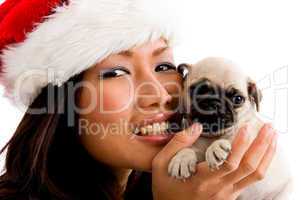 portrait of smiling woman with christmas hat and pug