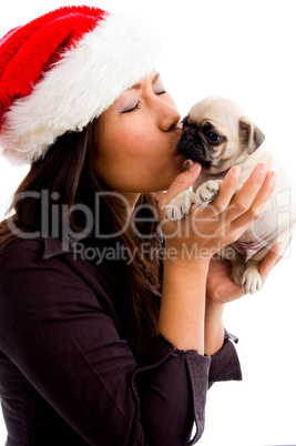 female with christmas hat and kissing puppy