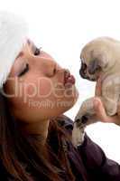 young woman playing with cute puppy