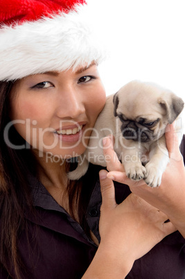 woman with cute puppy and christmas hat