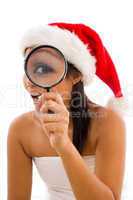 woman posing in towel and wearing christmas hat with magnifier