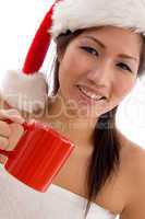 young woman with christmas hat holding coffee mug