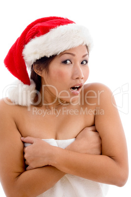 young woman in towel wearing christmas hat