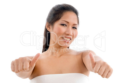 young woman in towel showing thumb up