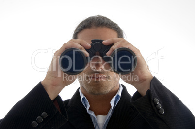 young handsome executive looking through binoculars