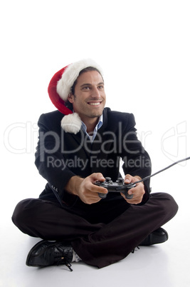 young american executive in christmas hat playing videogame