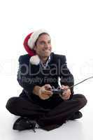 young american executive in christmas hat playing videogame