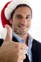 handsome businessman wearing christmas hat gesturing thumbs up