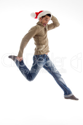 young male wearing christmas hat and jumping