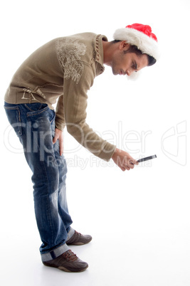 man wearing christmas hat and viewing from magnifier