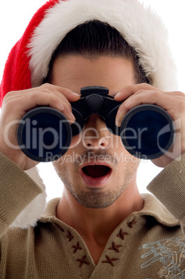 handsome guy looking into binoculars and surprised