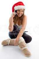 female wearing christmas hat and talking on mobile