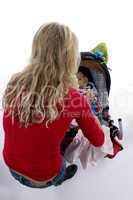 back pose of young mother with her baby in pram