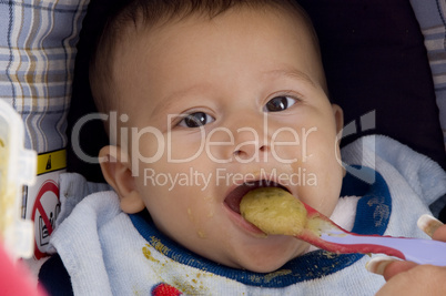 close up of cute baby eating food