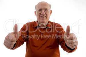 old man showing thumb up with both hands