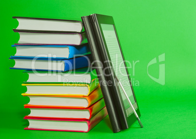 Electronic book reader with stack of printed books