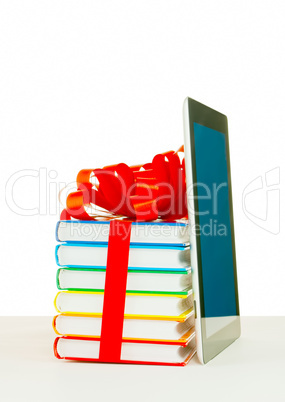 Books tied up with ribbon and tablet PC against white background